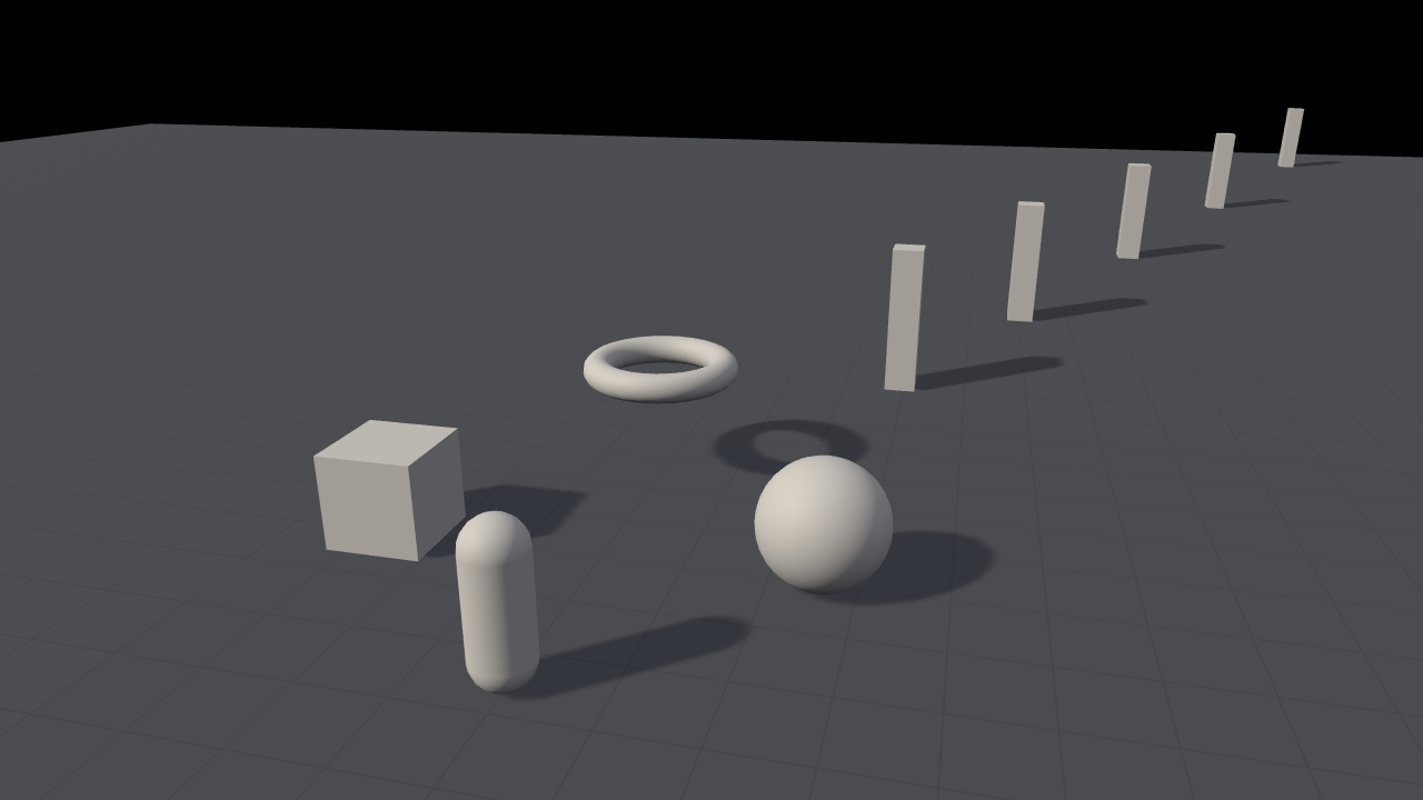 A sphere, a torus, a box and a capsule standing on a pale grid floor in daylight, each with a soft shadow stretching to the right, and a line of five pillars receding into the distance with shadows of their own.